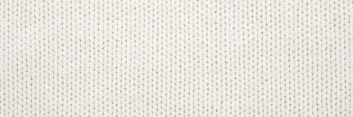 White soft knitted fabric pattern background. Closeup. Wide banner. Top down view.