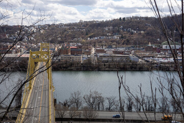 Pittsburgh, Pennsylvania, USA &ndash; March 18, 2024: The 10th Street Bridge crosses the Monongahela River toward Pittsburgh&rsquo;s South Side, seen on a cloudy late winter day from an elevated viewpoint.