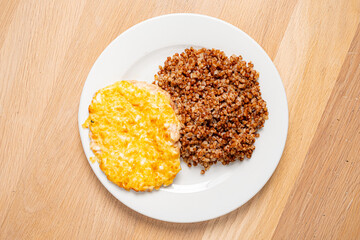 A delicious baked cheese plate accompanied by perfectly cooked buckwheat showcases comfort food