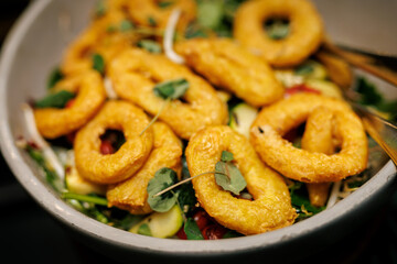 Crispy Fried Onion Rings on Fresh Salad Platter.
