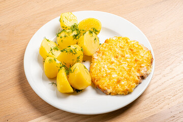 A delectable plate showcases tender boiled potatoes paired with a cheesy fish fillet