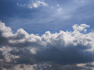 Fototapeta premium Beautiful contrast between bright white and dark grey clouds forming a dramatic and moody sky