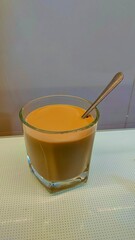 A cup of espresso coffee with a natural look lies on the floor with morning light and a blurred background. coffee wallpaper.