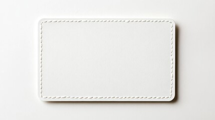 Blank white rectangular label with stitched border on white background.