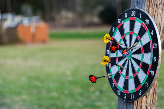 Dart board with throwing darts on it with copy space