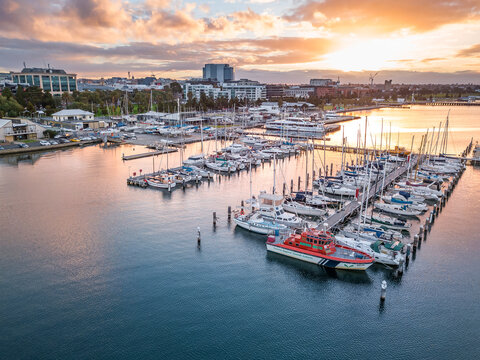 Looking down on rows of boats and yachts at a marina at sunset