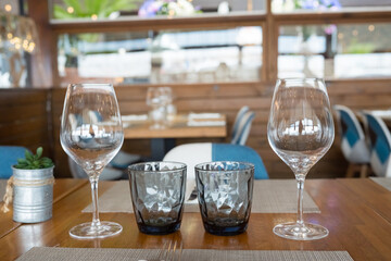 Elegant table setting with wine and water glasses in stylish restaurant