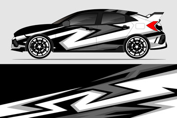 Obraz premium Stylish modified hatchback car with dynamic black and white design on a gray background