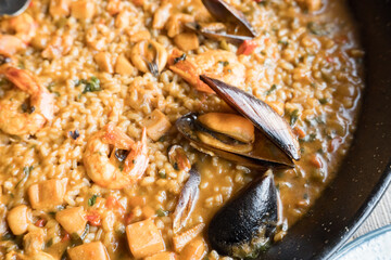 Delicious seafood paella with shrimp and mussels in a pan