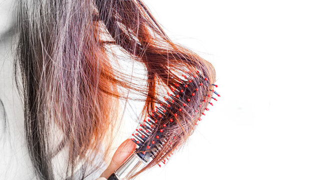 Closeup portrait of female model holding messy hair in hands, Combing with brush and pulls long hair, Daily preparation for looking nice, Long Disheveled Hair, Holding Messy Hair