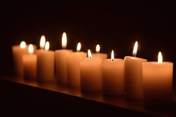 group of lit candles sitting on top of a table