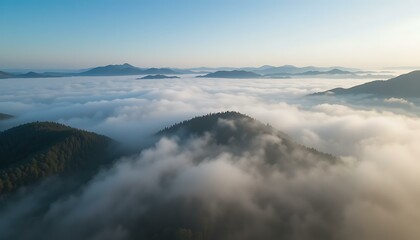 Fototapeta premium Majestic Mountain Peaks Emerging from a Sea of Clouds at Sunrise