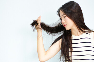 Combing with brush and pulls long hair. Daily preparation for looking nice, Long Disheveled Hair,Holding Messy Unbrushed Dry Hair In Hands. Hair Damage, Health And Beauty Concept.