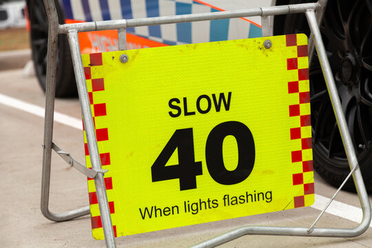 Slow 40 when lights flashing sign beside police car