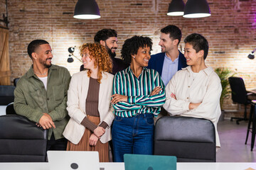 Multi ethnic team smiling and interacting in modern office