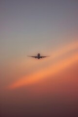 Airplane flying at sunset