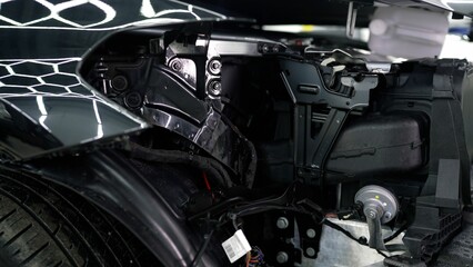 Obraz premium Car restoration process focusing on repairing front section, showcasing professional mechanic's expertise in automotive bodywork and detailed vehicle repair techniques