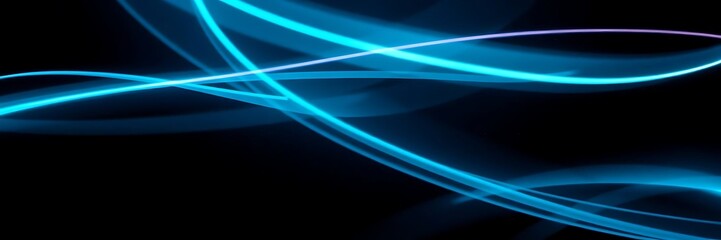 Fototapeta premium Abstract Image of Glowing Blue Light Trails Against a Dark Background
