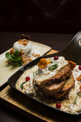 Draniki with chanterelle mushrooms, cream sauce and meat
