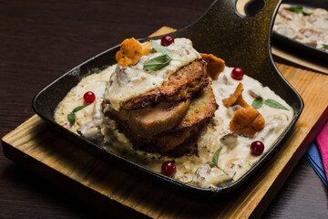 Draniki with chanterelle mushrooms, cream sauce and meat