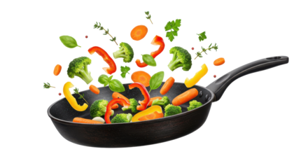 Colorful vegetables being tossed in a frying pan against a clean background