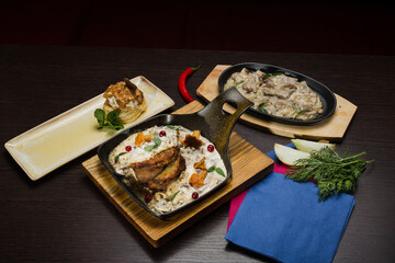Set of potato pancakes with mushrooms, meat in sauce and dessert