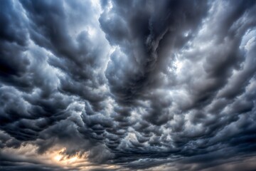 Obraz premium Dark storm sky texture with dramatic clouds and light break