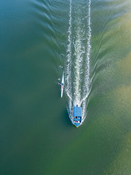 Looking down on a small boat and a kayak on a cam river