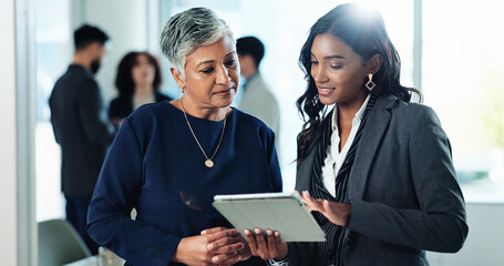 Tablet, business women and conversation in office, planning or mentor help intern with financial...
