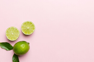 Lime fruits with green leaf and cut in half slice isolated on white background. Top view. Flat lay...