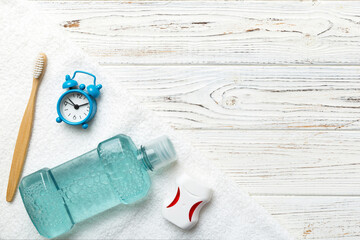 Mouthwash and other oral hygiene products on colored table top view with copy space. Flat lay....