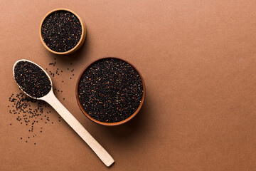 quinoa seeds in bowl and spoon on colored background. Healthy kinwa in small bowl. Healthy superfood