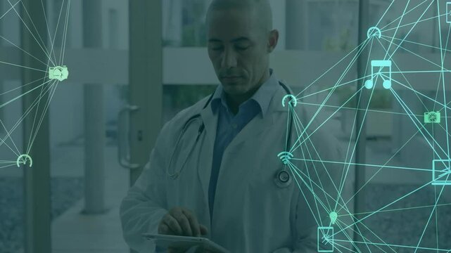 Using tablet, doctor in school viewing animation of medical icons and network