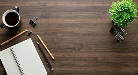 Overhead View of Organized Workspace Notebook Writing Pencil Coffee Mug Desk Plant Clips Wood Surface