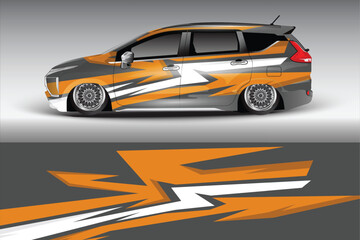 Stylish orange and gray sports car with dynamic graphics parked on a smooth surface, showcasing custom design