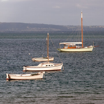 four boats anchored at sea