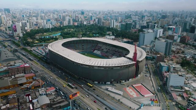 Aerial View of Estadio Nacional del Per&uacute; and Surrounding Area in Lima. This aerial footage captures the Estadio Nacional del Per&uacute; in Lima, showcasing the iconic stadium and the surrounding area