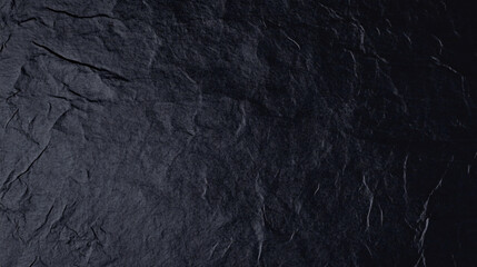 Textured black paper background with deep, rich tones and subtle creases, perfect for design