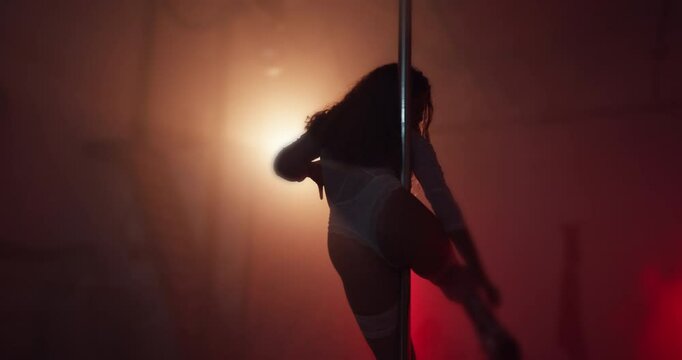 Exotic, dancer and flexible with pole, woman and artist with balance for event and person with skills. Entertainment, private party and rehearsal of routine, performer or dancing on stage at night