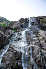 Scenic Waterfall Descending Over Rocky Cliffs into Lysefjord Fjord Waters, Stavanger, Norway, June 2018