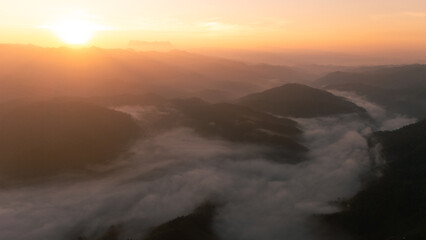 Clouds on high mountain peaks in the rainy season in the Asian rainforest.	