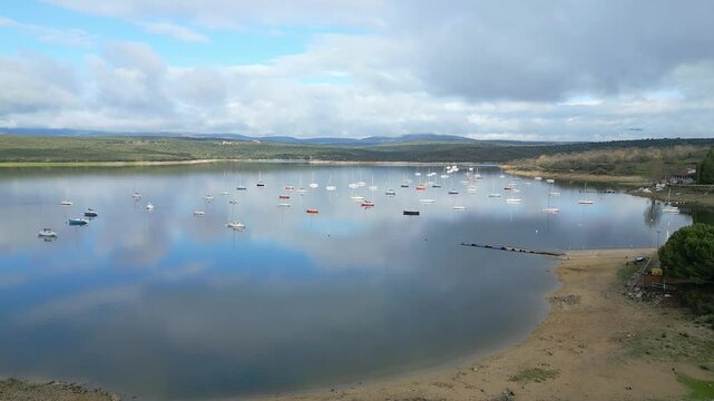 Atazar reservoir full of small pleasure boats in the Community of Madrid, Spain.