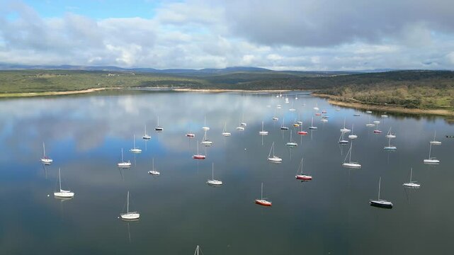 Atazar reservoir full of small pleasure boats in the Community of Madrid, Spain.