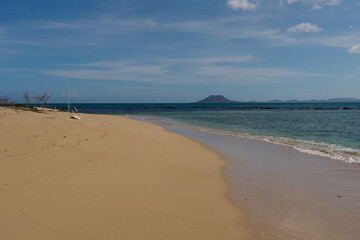 Sandy beach on one of the Seven Brothers Islands with El Morro mountain in the background. Dominican Republic.