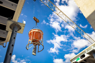 Crane is carry, lifting cone tank for concrete over construction site