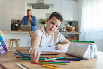 Student, drawing or boy writing homework on notebook education for growth development. Project, creative or young kid artist with color pencil learning or working on sketching skills.