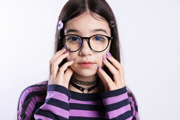 Teenage girl in stylish clothes and glasses posing on white background. Makeup in anime style