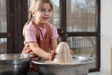 Hobby and craft. Smiling girl making pottery indoors