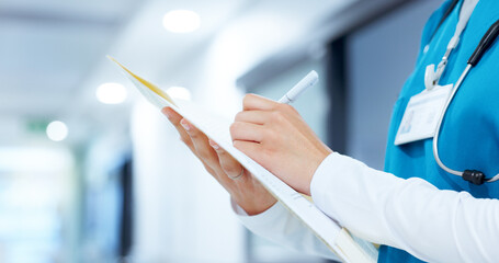Insurance, medical and writing with hands of nurse closeup in hospital for records or report. Cardiology, file and notes with healthcare professional in hallway of clinic for diagnosis or treatment