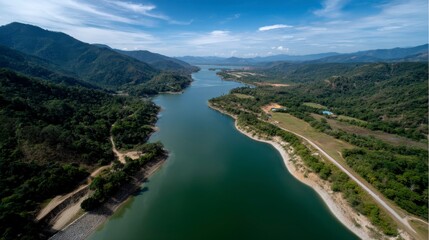 Fototapeta premium Aerial View of Large Reservoir Surrounded by Scenic Mountain Landscape